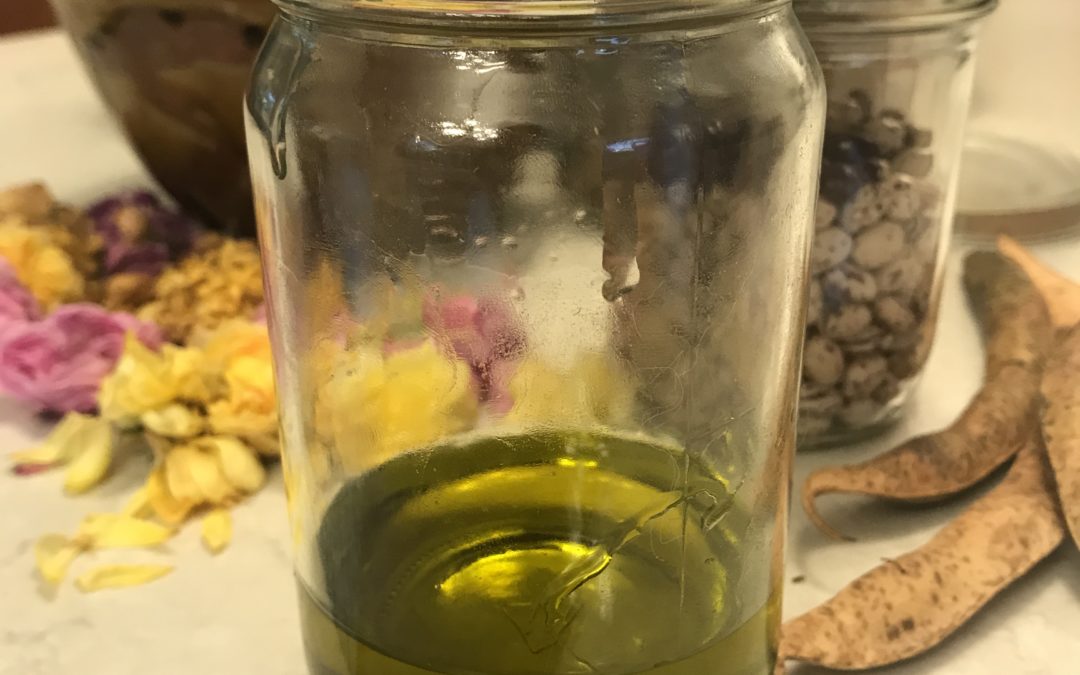 Homemade herbal oil in a glass jar